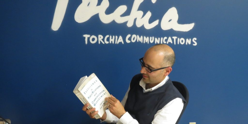 Daniel Torchia with Grunig book, "Excellence in Communications and Public Relations Management"